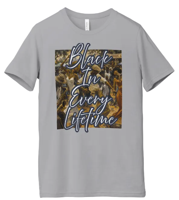 A light gray short-sleeve crewneck t-shirt featuring a square graphic print on the chest with the phrase 'Black In Every Lifetime' in white script over a camouflage background.